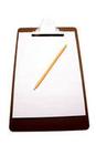 A brown clipboard with paper and pencil on top of it.