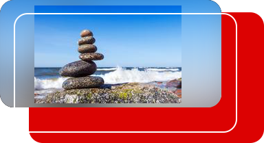 A stack of rocks on top of each other near the ocean.